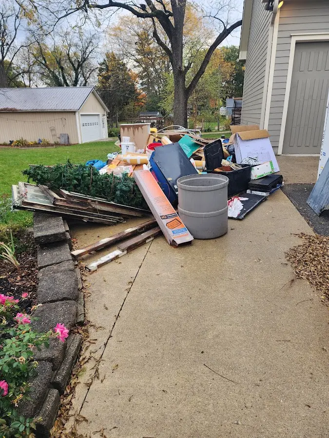 Dumpster being loaded with debris for Estate Cleanout Dumpster Rental in Paoli